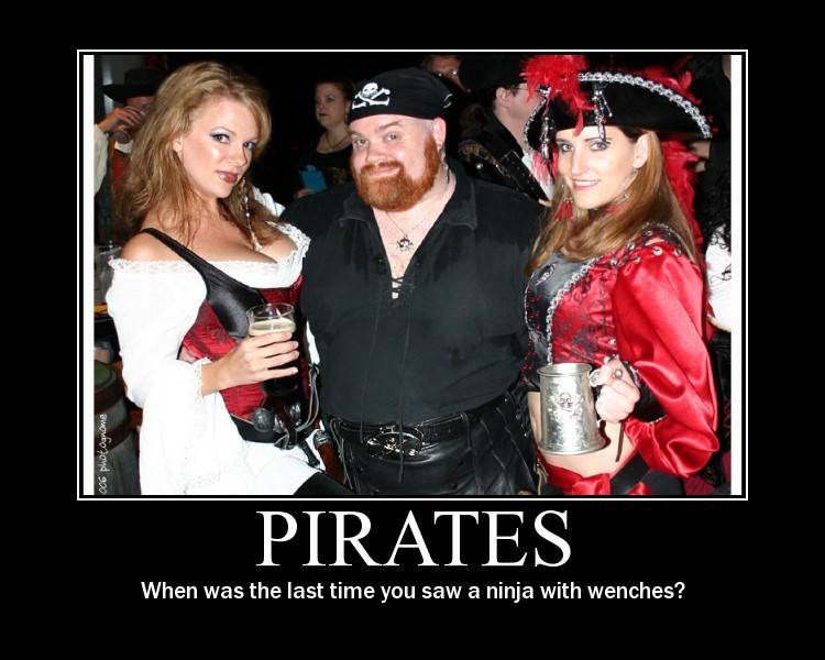 Guy dressed as pirate with two girls hanging off him... captioned PIRATES: when was the last time you saw a ninja with wenches?