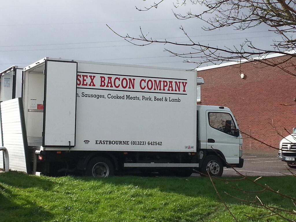 Truck with rear door covering signage, resulting in name SEX BACON