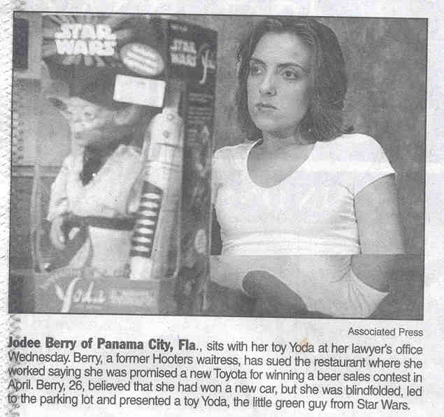 Jodee Berry of Panama City, Fla., sits with her toy Yoda at her lawyer's office Wednesday. Berry, a former Hooters waitress, has sued the restaurant where she worked saying she was promised a new Toyota for winning a beer sales contest in April. Berry, 26, believed that she had won a new car, but she was blindfolded, led to the parking lot and presented a toy Yoda, the little green guy from Star Wars.